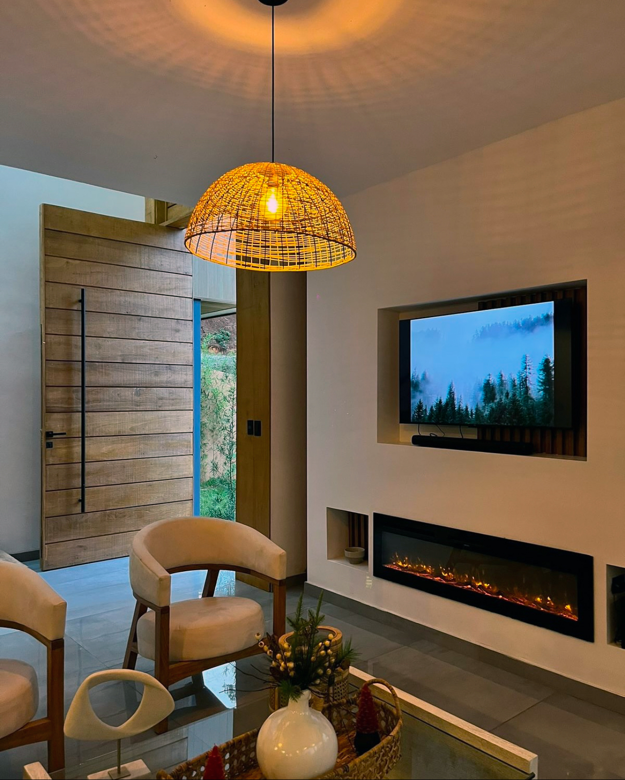 Villa living room with fireplace and rattan pendant lighting